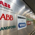 Collage of logos from Danish induction motor suppliers on a metallic background