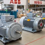 Three distinct induction motors displayed on a factory floor
