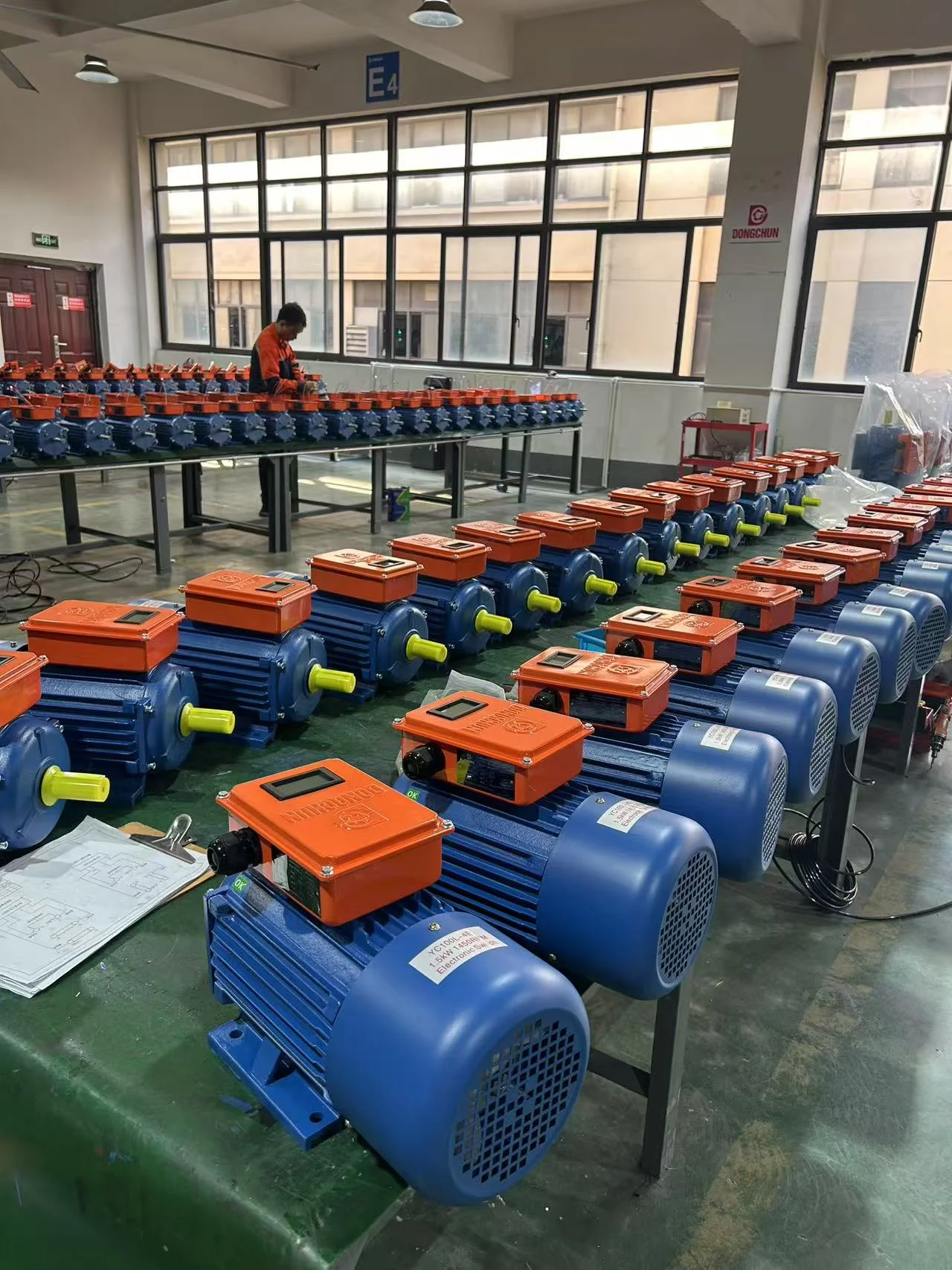 Procurement officer checking motor weight against IEC standards at receiving warehouse Buyer inspecting electric motor weight and nameplate at warehouse