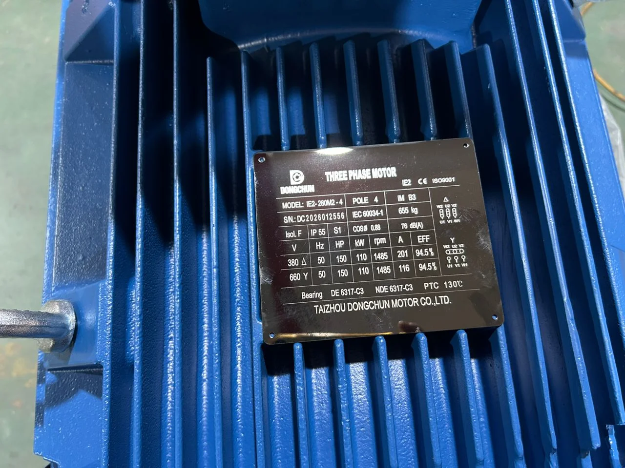 Three-phase electric motor undergoing power output testing on a dynamometer test bench Electric motor on dynamometer test bench in factory