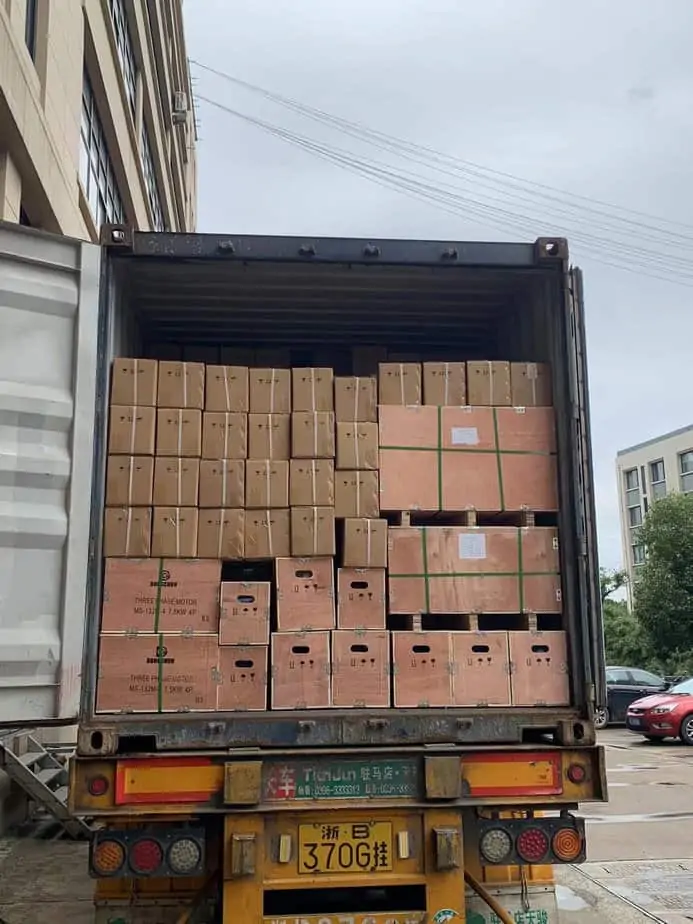 Freight container filled with electric motors at a busy port
